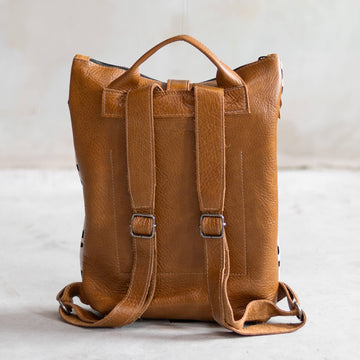 Sandra Cowhide & Leather Backpack by Clemés in Champagne, roll-top studio shot