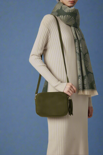 Model wearing the Olive Éloise suede tassel bag with a scarf, studio shot