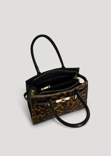 Open interior of the Leonora leopard calf hair bag, showing two compartments split by a zip centre pocket