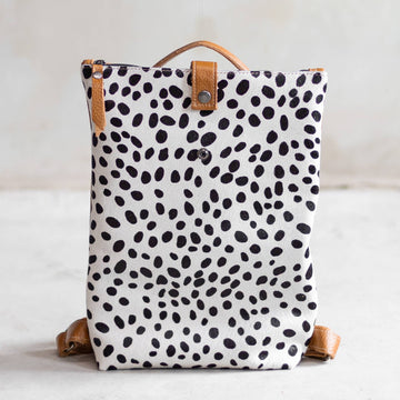 Sandra Cowhide & Leather Backpack by Clemés in Dalmatian print, studio shot