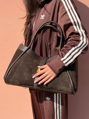 Woman wearing the Brown Bianca Large suede tote on her shoulder in a tracksuit