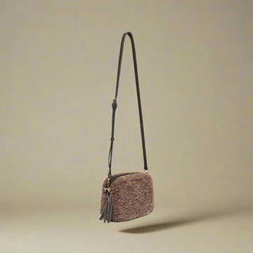 Georgette Shearling & Leather Tassel Camera Bag by Clemés in Pink, studio shot with long strap