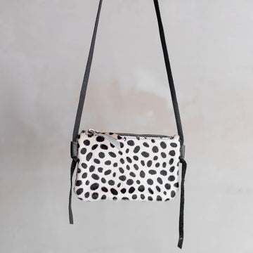 Anouk Cowhide Crossbody by Clemés in Dalmatian, studio shot with long strap
