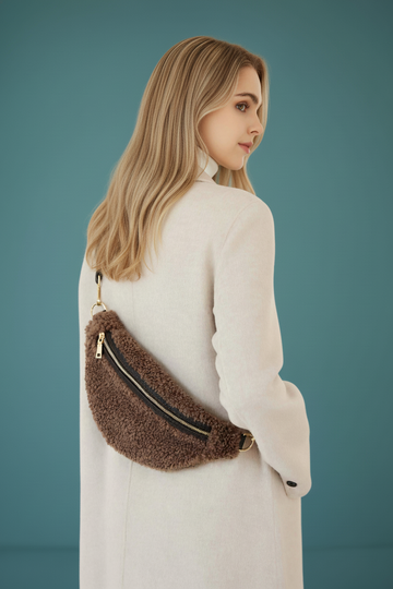 Woman wearing the Taupe Nevina bum bag in a cream sweater