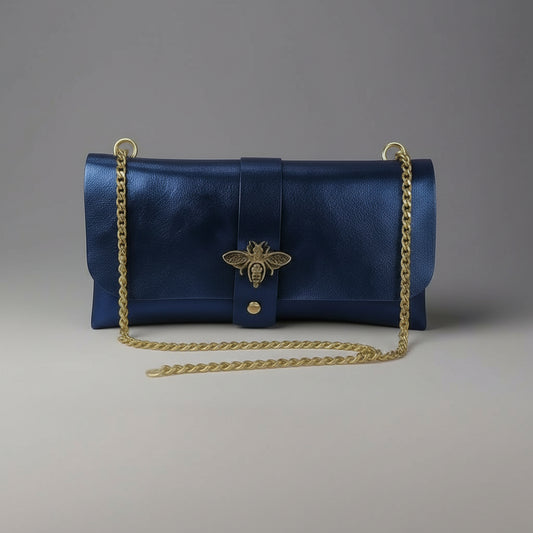 Anima Suede Leather Metallic Clutch Shoulder Bag by Clemés in Navy, three-quarter studio shot on grey background