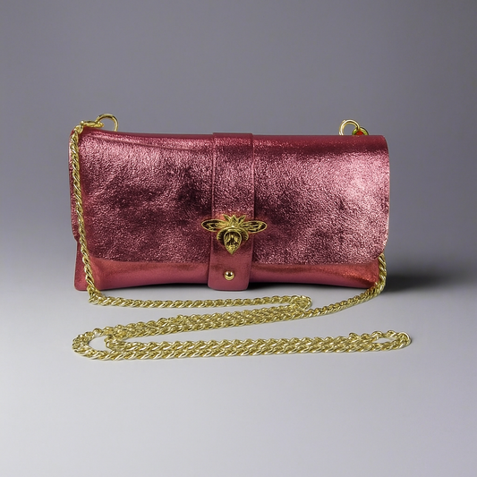 Anima Suede Leather Metallic Clutch Shoulder Bag by Clemés in Rose, three-quarter studio shot on grey background