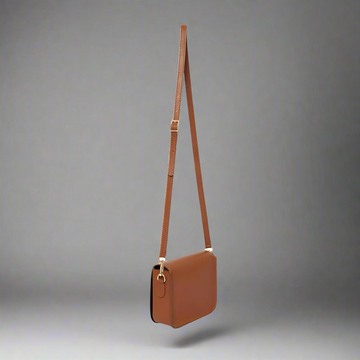 Chiara Leather Crossbody by Clemés in Tan, studio shot with long strap