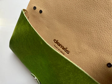 Anima Suede Leather Metallic Clutch Shoulder Bag by Clemés in Apple Green, flat lay showing the nude leather flap