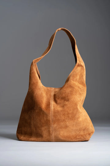 Silvia Suede Slouch Hobo Bag by Clemés in Caramel, studio shot on grey background
