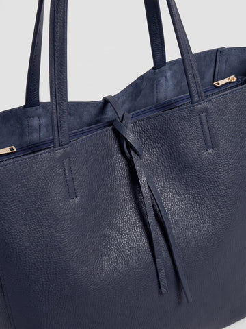 Carlotta oversized leather tote by Clemés in Navy leather, close-up of the top edge with rolled handles and knotted leather tie