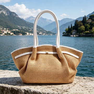 Woman with the Oyster Serafina raffia shopper beside a mountain lake