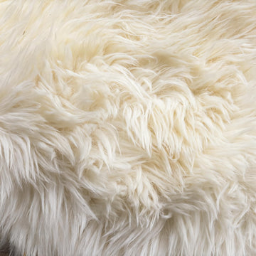 Close-up of natural undyed ivory New Zealand sheepskin wool with bright ivory tips and faint cream at the roots
