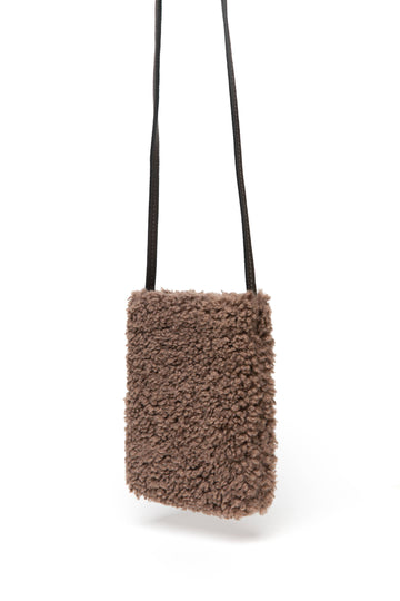 Pia Faux Shearling Phone Crossbody Bag by Clemés in Mocha, studio shot with long strap