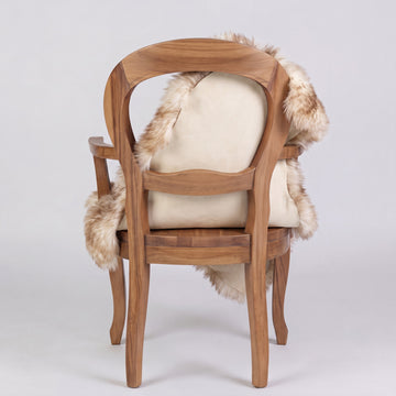 Eclipse sheepskin rug over the back of a chair showing the cream suede underside