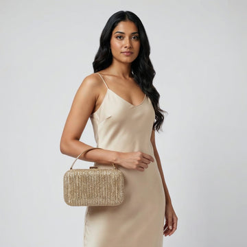 Model with the Gold Odette Crystal Minaudière Clutch under her arm, studio shot