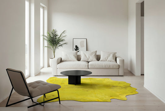 Acid wash yellow Brazilian cowhide rug in a minimalist living room with white sofa