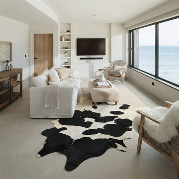 Black and white cowhide rug in a coastal living room