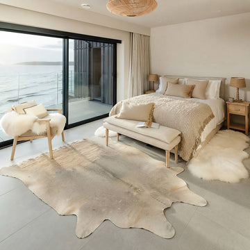 Pale grey cowhide rug in a coastal ocean-view bedroom