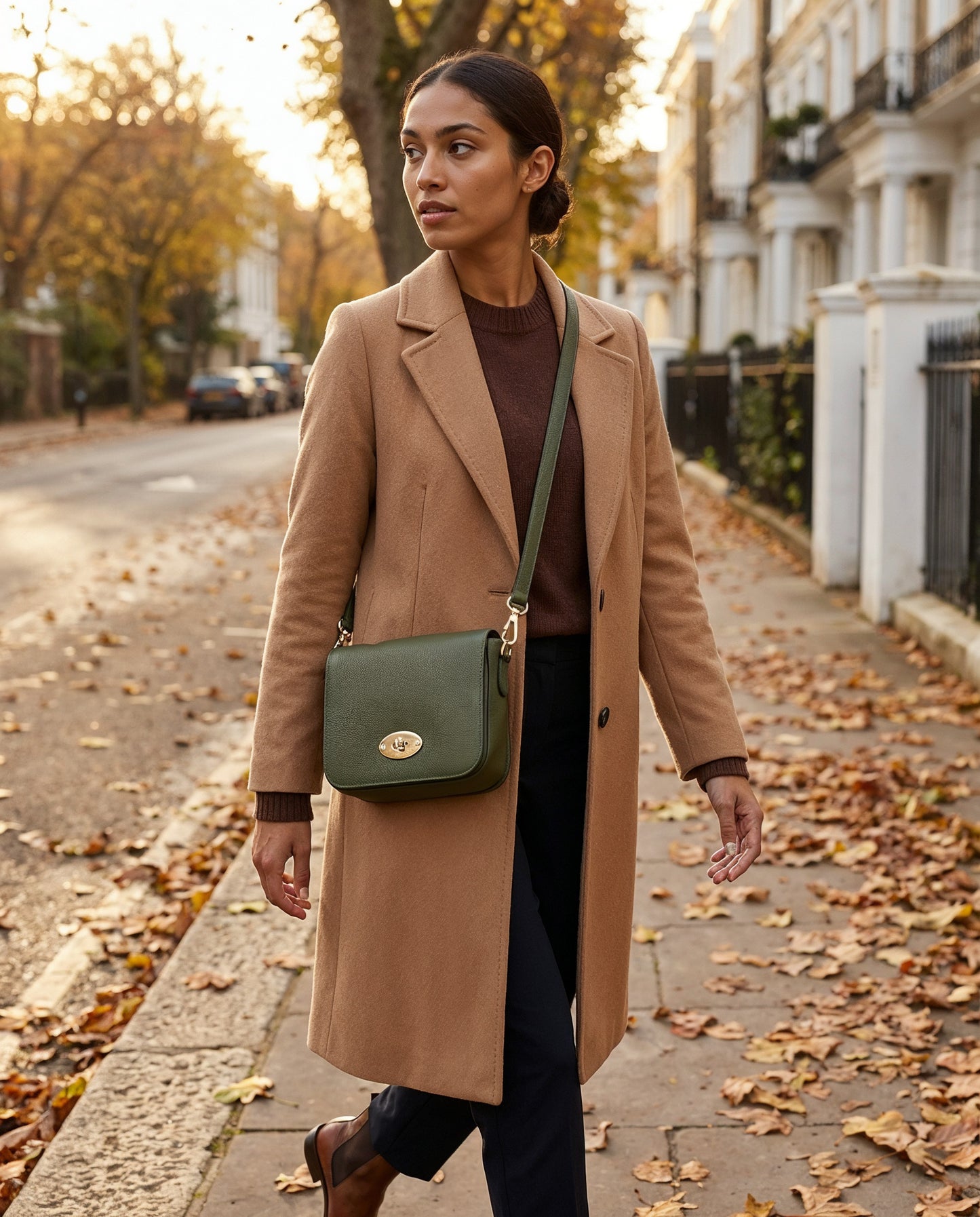 Woman wearing the Dark Olive Chiara crossbody bag on an autumn street