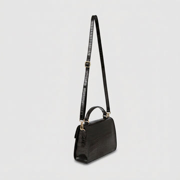 Margot Croc crossbody bag, three-quarter angle with strap raised, studio product photo on grey background
