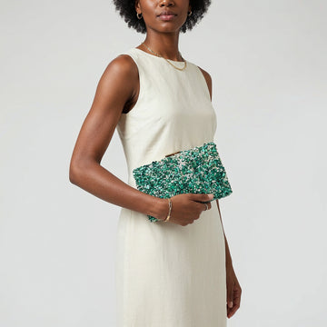 Model with the Turquoise Gemma Natural Stone Box Clutch tucked under her arm, studio shot