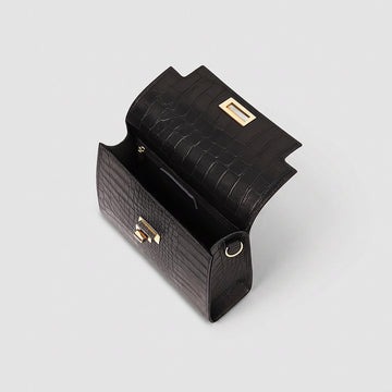 Margot Croc crossbody bag in black open showing the interior lining, studio product photo on grey background