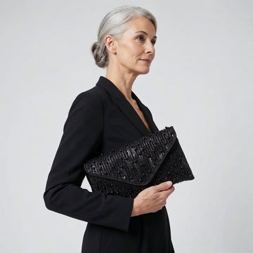 Model with the Black Perlette Pearl & Crystal Envelope Clutch under her arm, studio shot