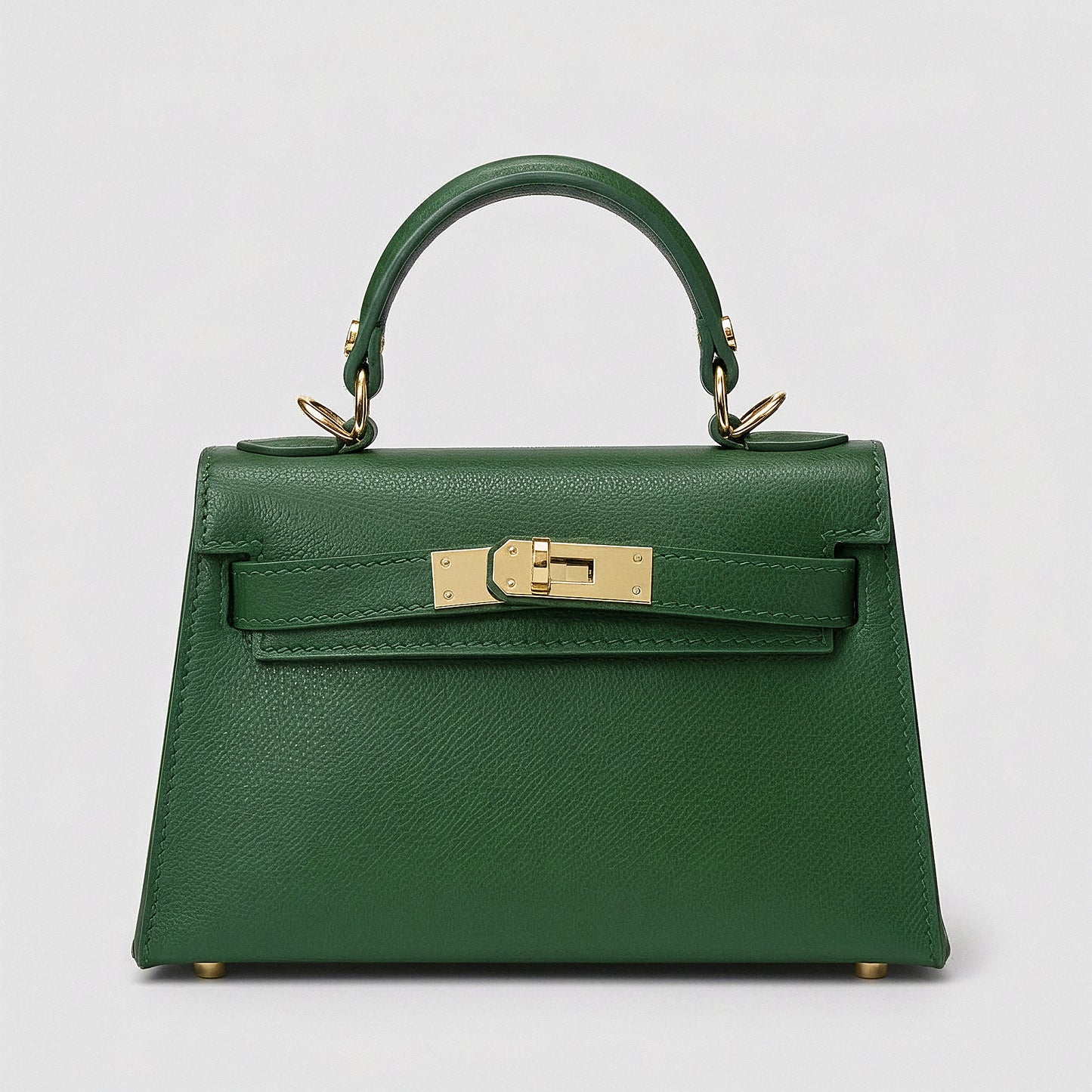 Clemés Mini Kelly mini handbag in forest green Epsom leather with gold-tone hardware on a grey studio background