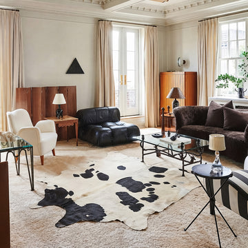 Black and white cowhide rug in an elegant cream living room