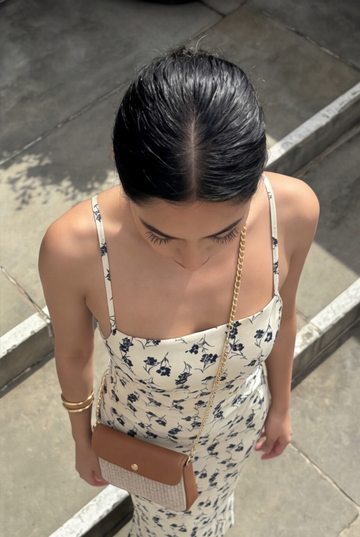 Woman wearing the Oyster Élodie flap bag on a chain strap, overhead view