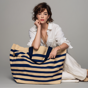 Woman with the Navy Solène beach bag, reclining outdoors