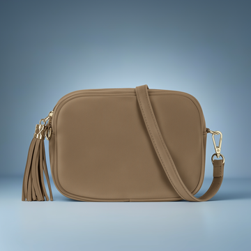 Éloise Real Suede Tassel Camera Bag by Clemés in Taupe, three-quarter studio shot on grey background