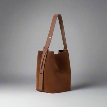 Serena Suede & Leather Bucket Shoulder Bag by Clemés in Tan, studio shot on grey background