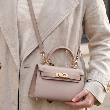Woman wearing the Dusty Rose Mini Kelly-Inspired handbag by Clemés crossbody at the hip