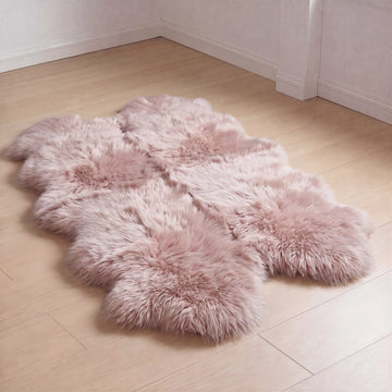 Light Rose quad sheepskin rug laid on a light wood floor