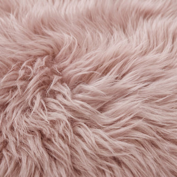 Close-up of Light Rose sheepskin wool showing the soft dusty rose pink fibres