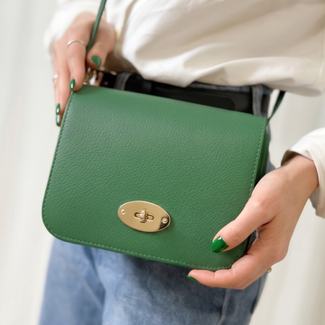 Chiara Leather Crossbody by Clemés in Green, held in hand