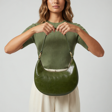 Model holding the Dark Olive Mezzaluna bag against her torso