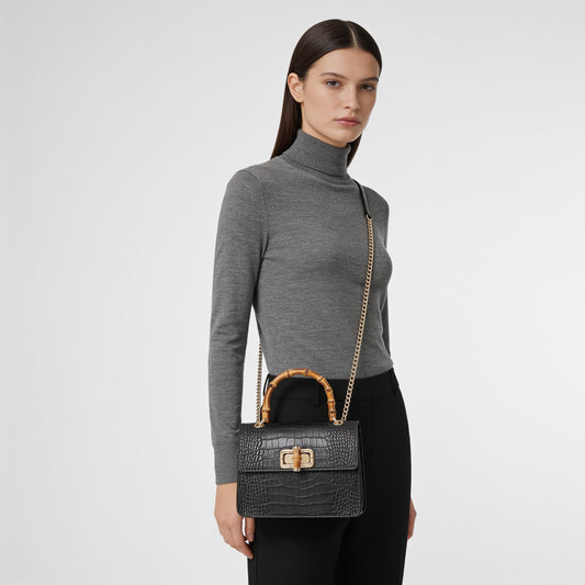 Woman wearing the Black Ginevra Bamboo-Handle bag crossbody