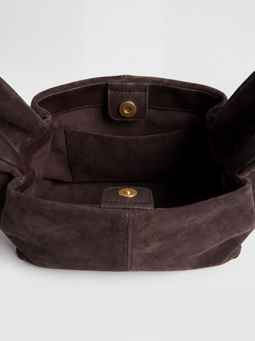 Inside the Dark Brown Noemi Suede Handbag showing the fabric lining, internal slip pocket and gold press studs