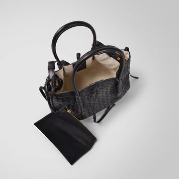 Ornella woven leather bag open at a high angle showing lining and coin purse