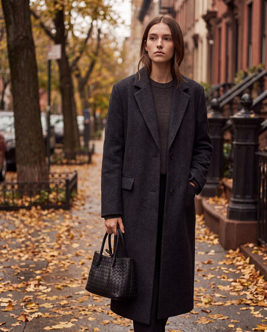 Woman with the Black Ornella woven leather bag on an autumn city street