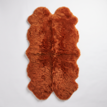Quad New Zealand Sheepskin Rug & Throw in Burnt Orange, studio shot
