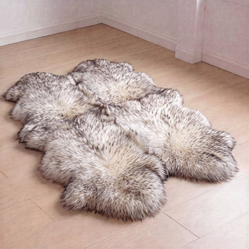 Wolf Tip New Zealand sheepskin rug, Quad size, ivory wool with dark tips, laid on a wooden floor