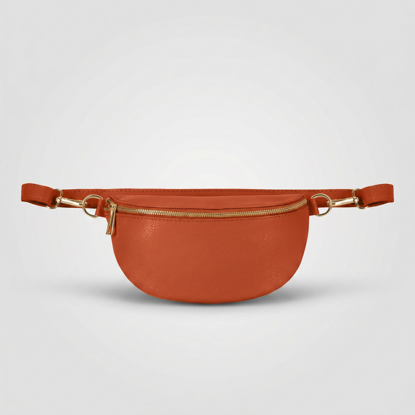 Romy leather crossbody bum bag in Burnt Orange on light grey studio background