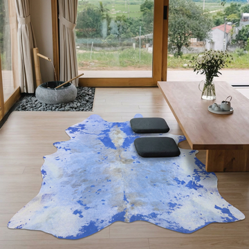 Blue acid wash cowhide rug styled beside a low wooden table in a serene japandi tea room