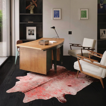 Metallic acid-wash cowhide rug styled on the dark timber floor of a moody luxe home study