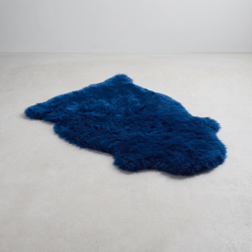 Cobalt Blue single sheepskin rug laid flat on a pale grey floor