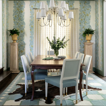 Caramel and ivory exotic printed cowhide rug styled on the floor of an editorial interior
