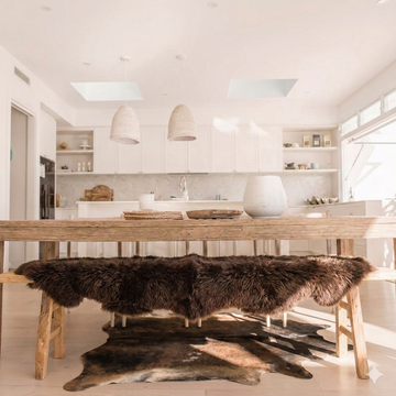 Natural cowhide rug styled on the floor of an editorial interior room